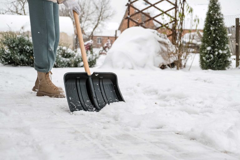 close-up-of-a-woman-cleaning-and-clearing-snow-in-2023-11-27-05-35-13-utc